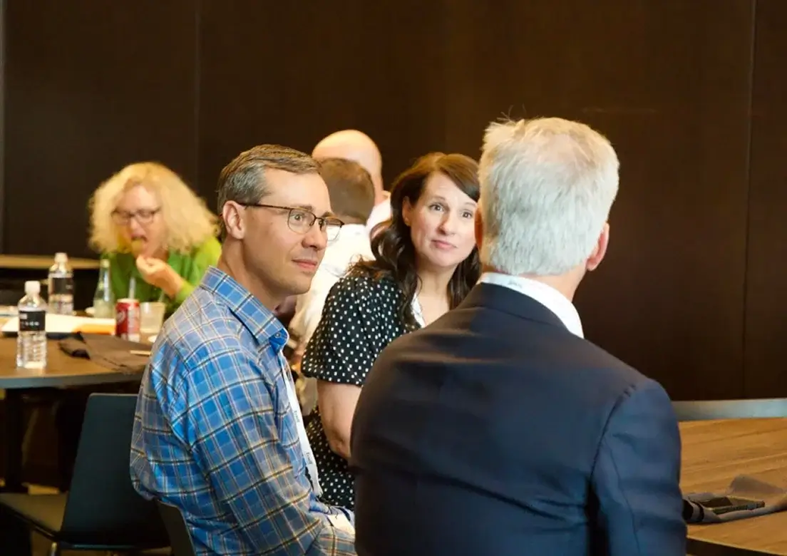 Workshop participants in conversation around a table